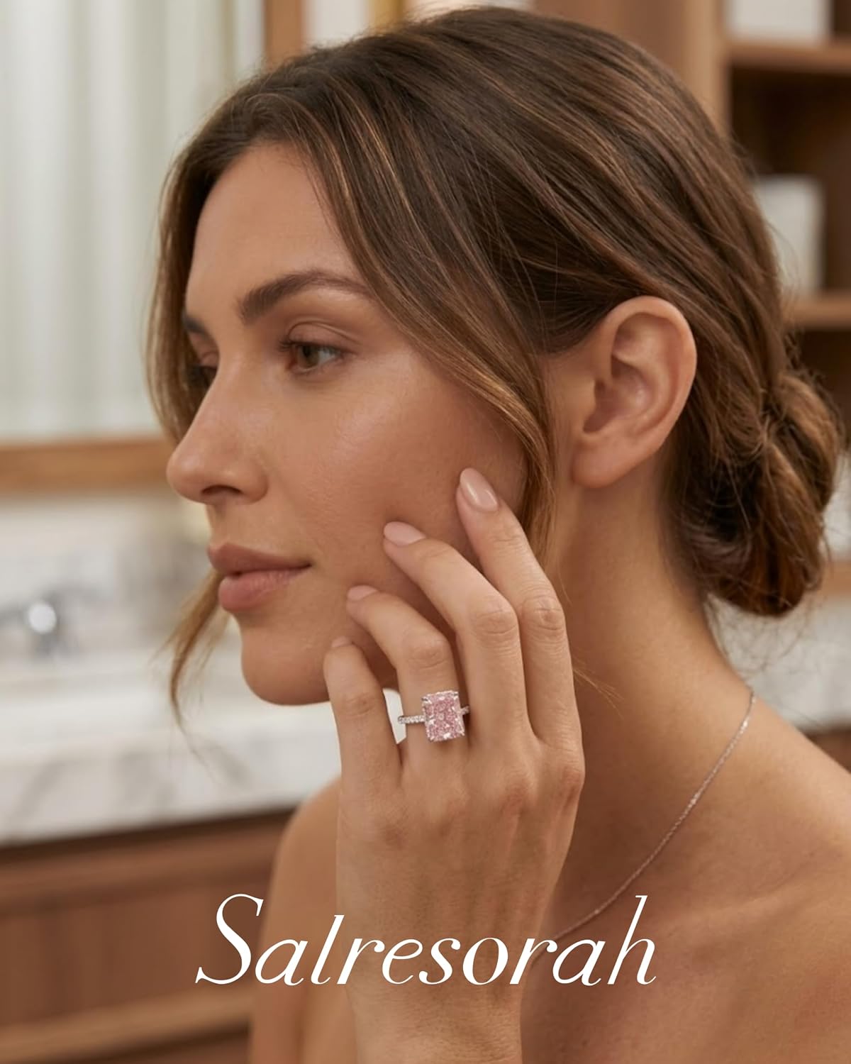 Model wearing pink radiant cut hidden halo ring