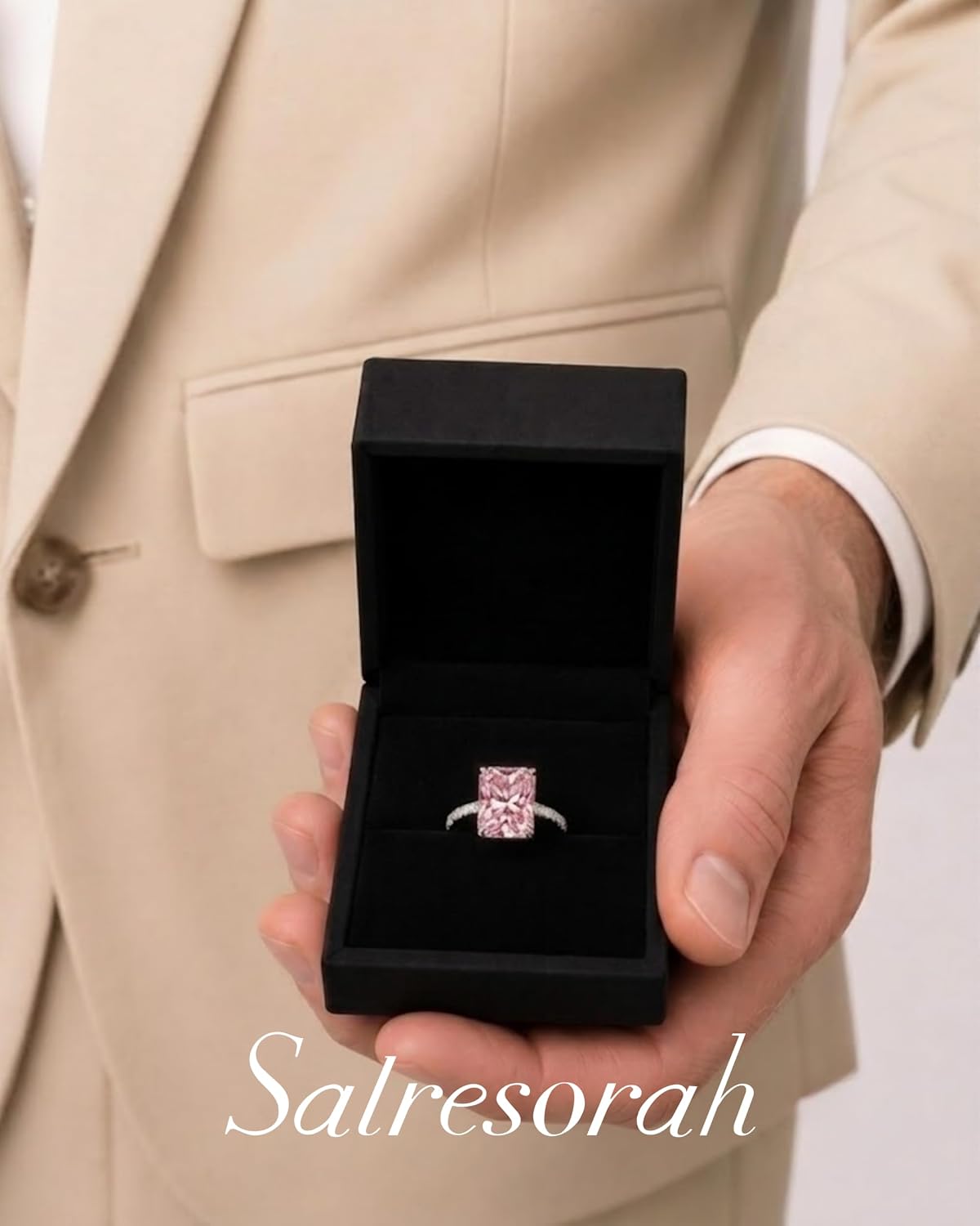 Pink radiant cut hidden halo ring presented in gift box