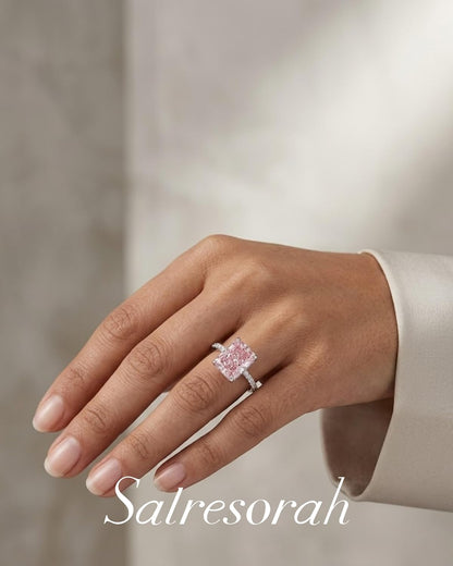Hand wearing pink radiant cut hidden halo ring