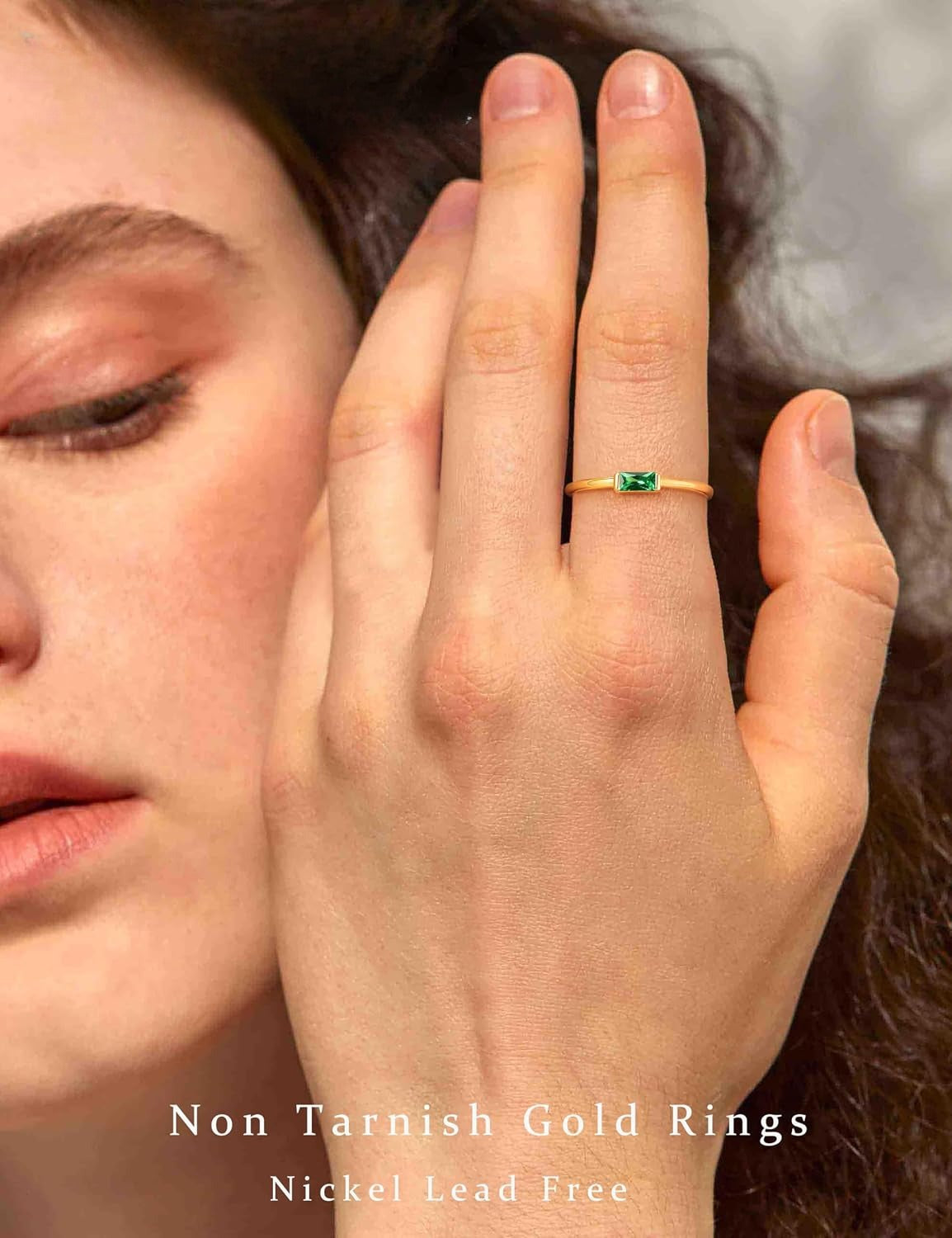 Gold stackable birthstone ring worn on hand